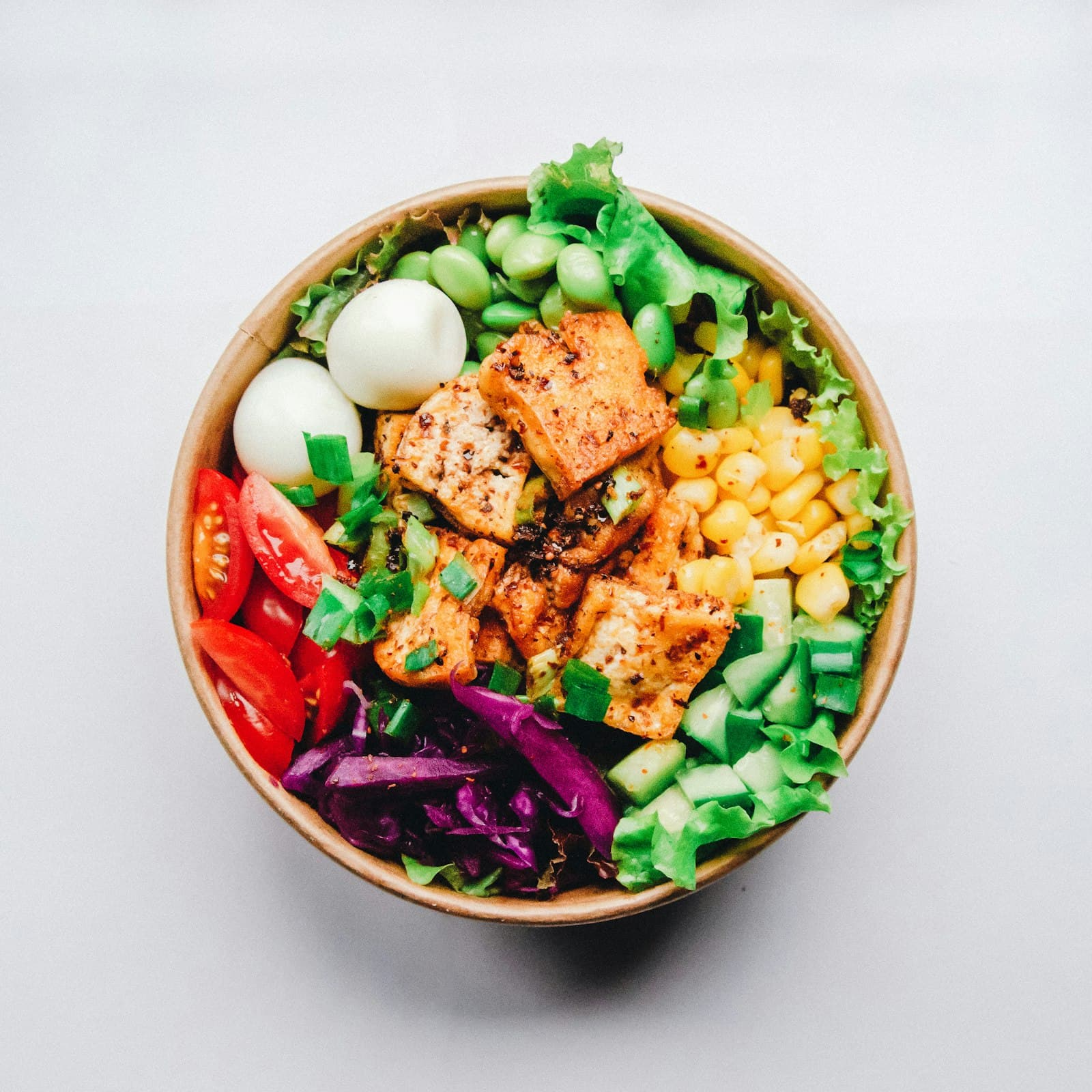 Colourful bowl of fresh vegetables, avocado and grains